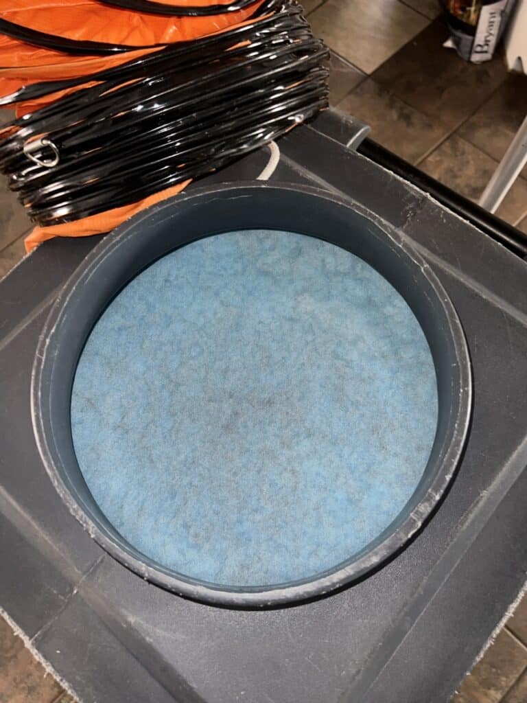 Close-up of HEPA filter on NIKRO air duct cleaning vacuum with orange collection hose