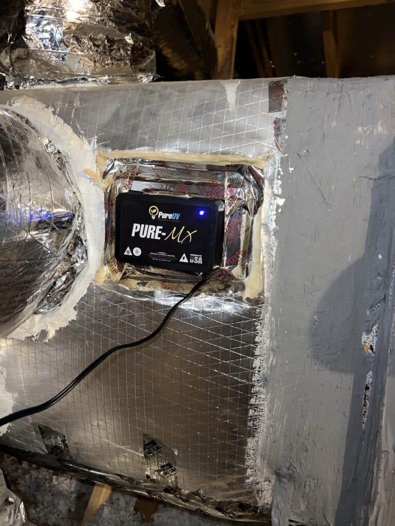 Whole house air duct cleaning service setup with NIKRO vacuum system in a residential home