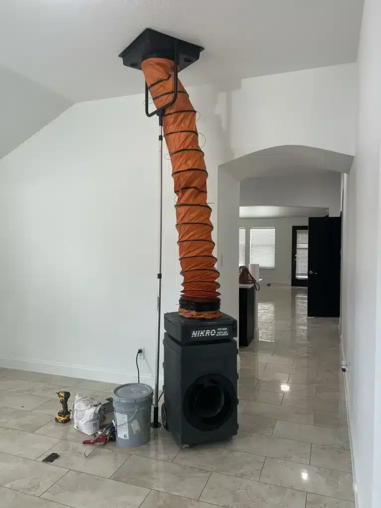Air duct cleaning: HEPA air scrubber hooked to the ceiling duct system inside a tiled home