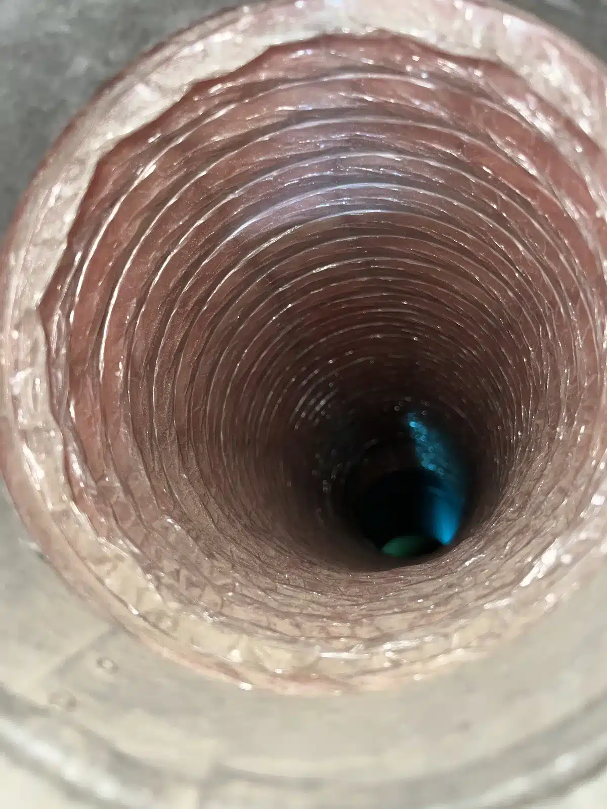 Air duct cleaning result: inside a flex duct with clean inner lining and clear airway