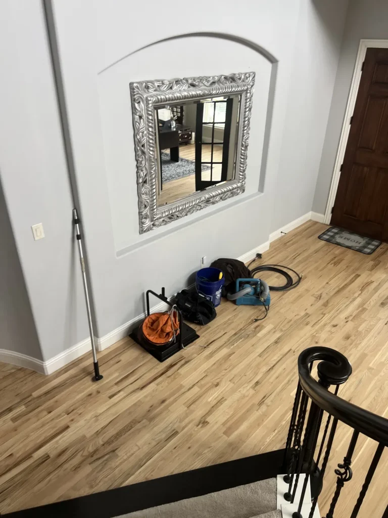 Air duct sanitizing equipment staged on protected floors in a home entryway