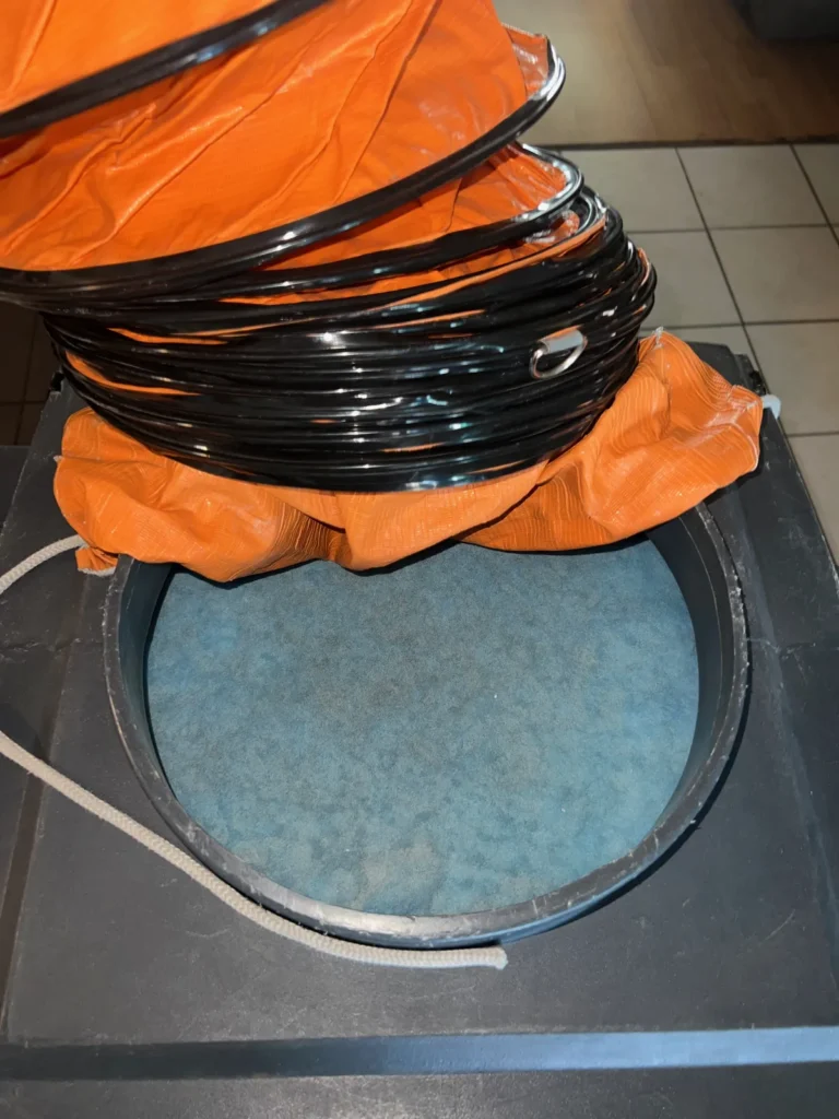 Setup: negative air machine hose sealed over an open return with the filter removed