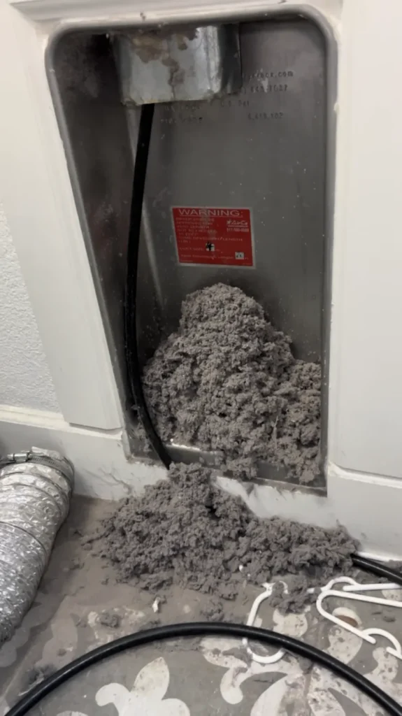 Dryer vent cleaning: heavy lint blockage removed from inside a recessed dryer vent box