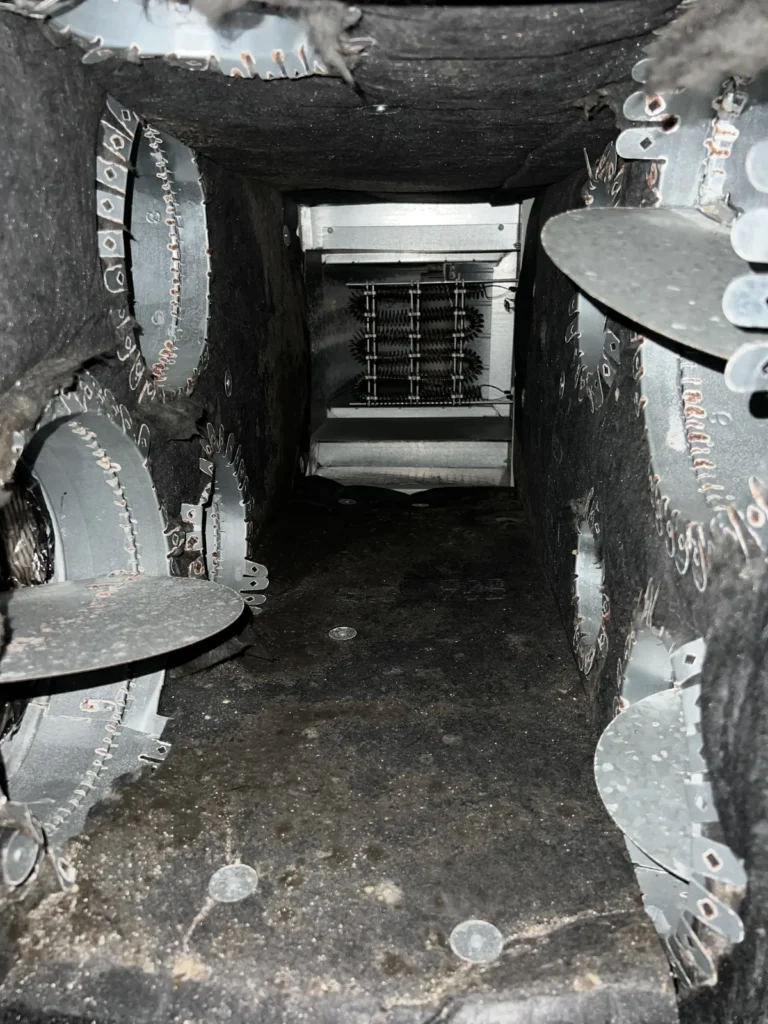 Looking down a return plenum toward the heating elements after cleaning, the air path a furnace or air handler pulls through