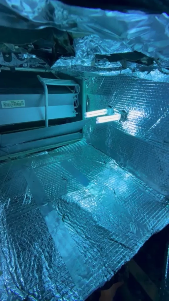 Plenum box repair: UV lamp installed inside a freshly foil-lined plenum next to the air handler