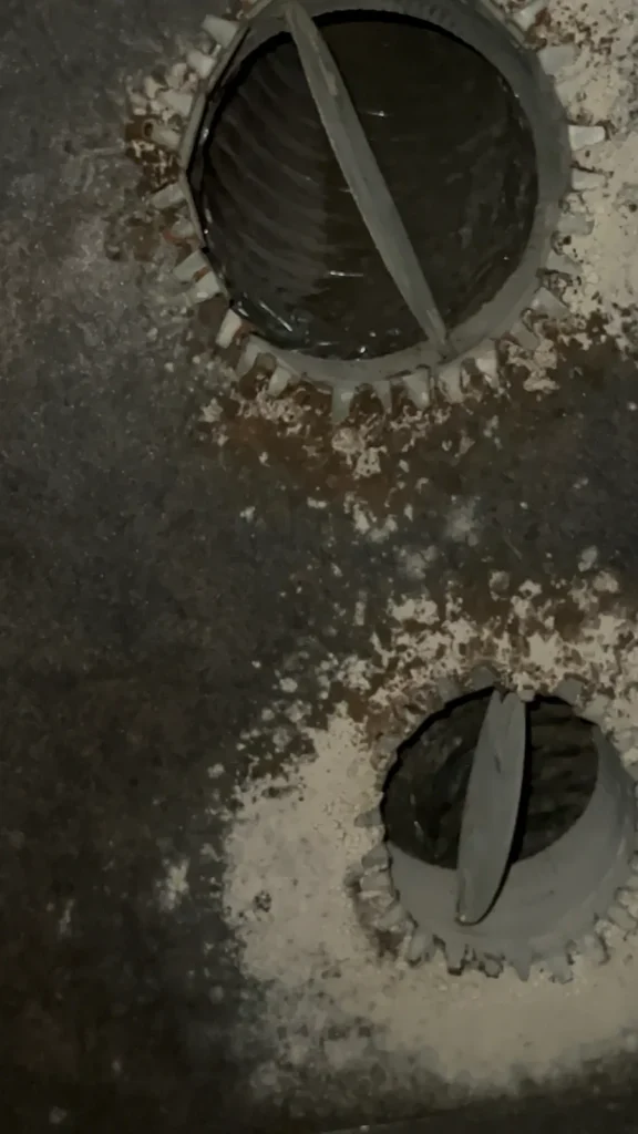 Plenum box repair: corroded plenum surface with rust and debris around two duct collar openings