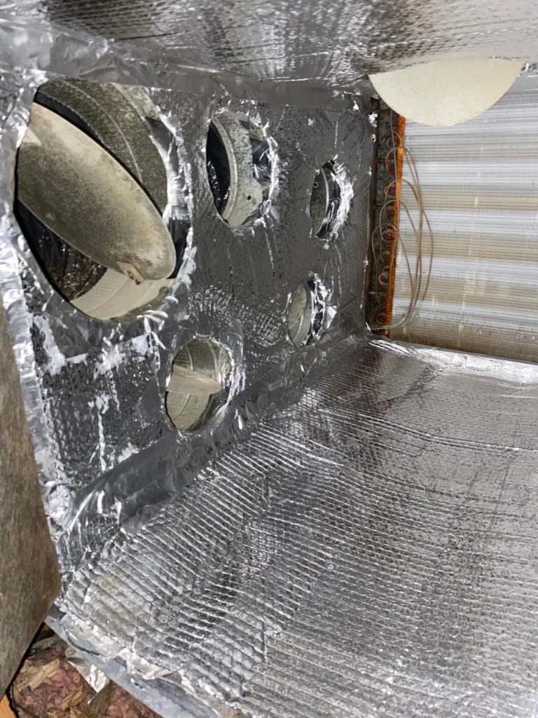 Plenum box repair: plenum relined with foil insulation, duct collar openings cut and sealed