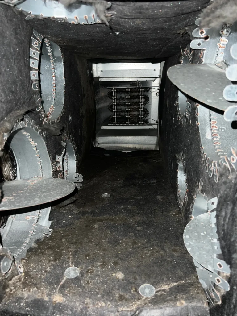 Plenum box repair: plenum interior with heating elements visible and takeoff collars along the walls