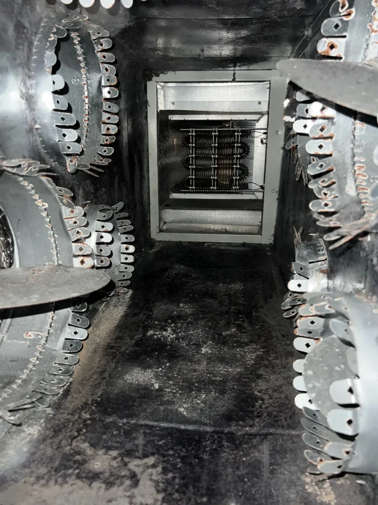 Plenum box repair: view down the plenum toward the heat strip frame, collars lining both sides