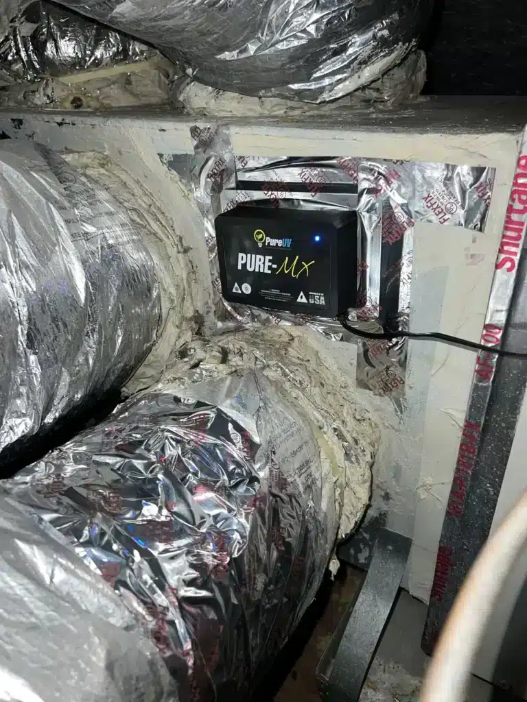 UV air purification unit installed on an HVAC plenum with sealed foil-taped ductwork
