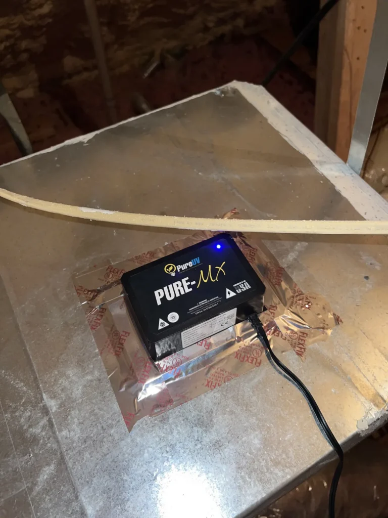 UV light installation: close-up of the powered control unit with blue indicator light on sheet metal