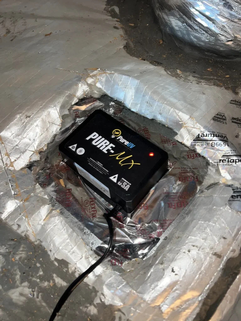 UV light installation: Pure-MX purifier mounted on a foil-taped duct plenum with power lead attached
