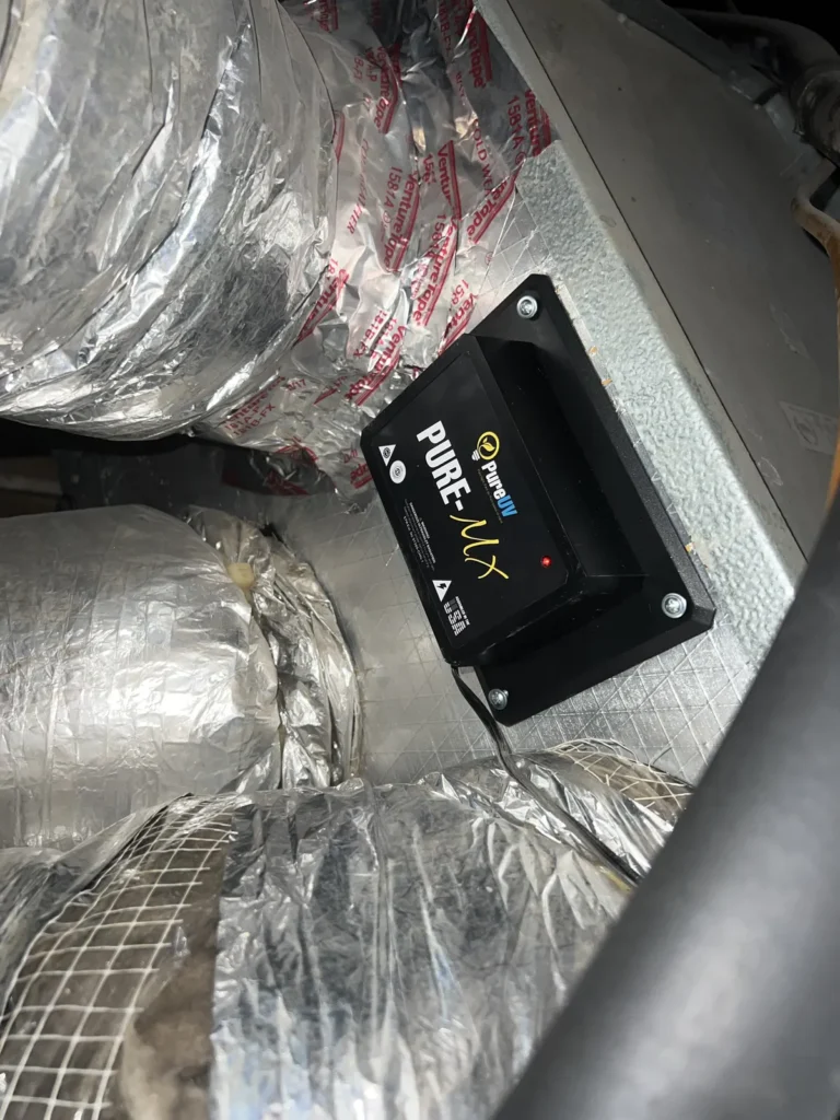 UV light installation: Pure-MX unit screwed to a metal plenum between insulated flex duct runs