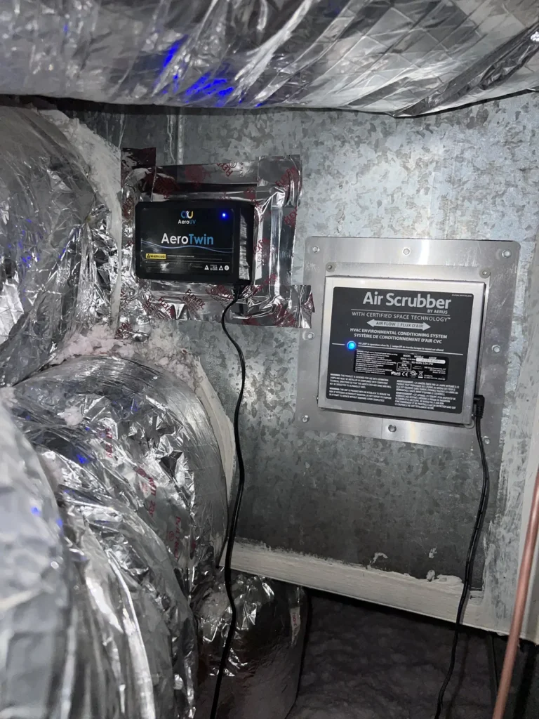UV light installation: AeroTwin unit and Air Scrubber cell mounted side by side on attic ductwork