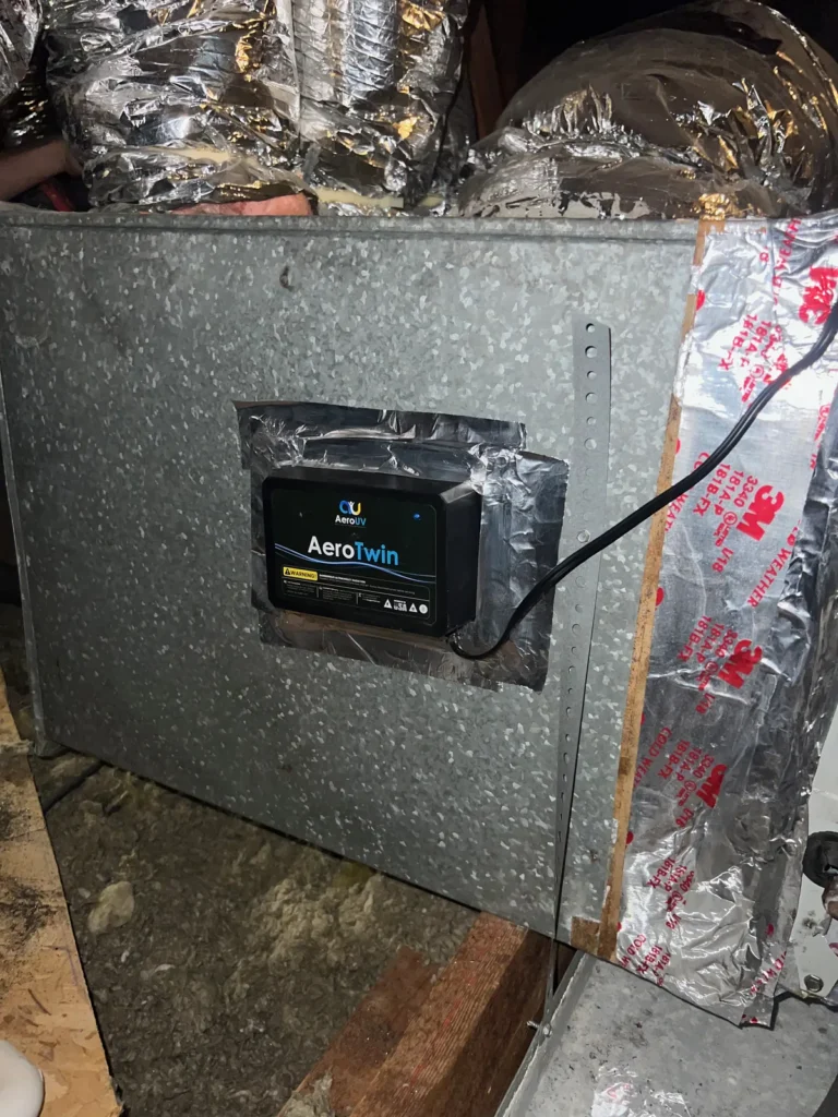UV light installation: AeroTwin unit mounted on a galvanized plenum with foil tape and flex ducts behind